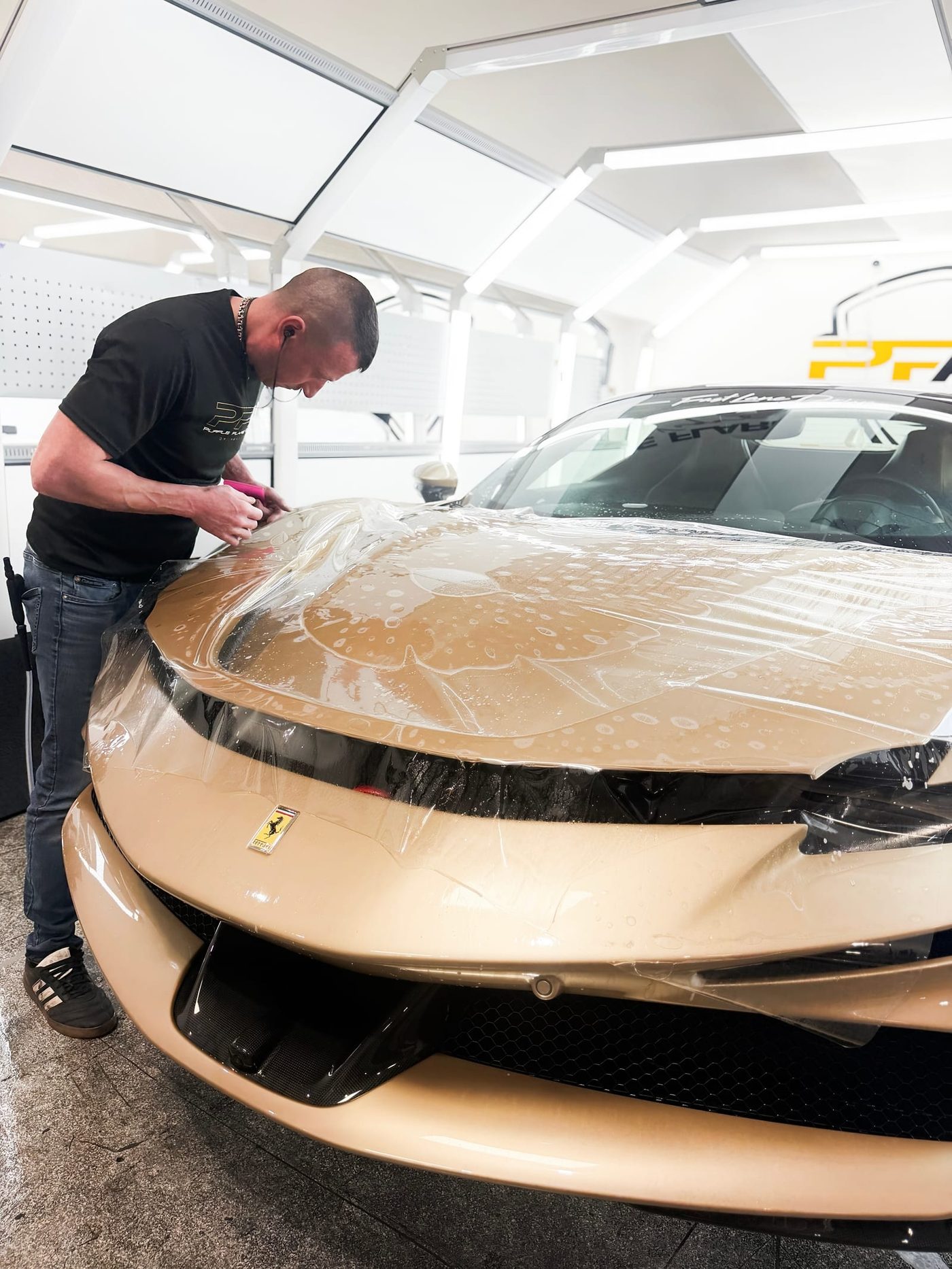 Installer Applying Paint Protection Film To A Ferrari Sf90 Hood